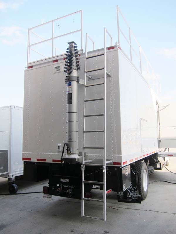 A trailer with a metal ladder and an antenna