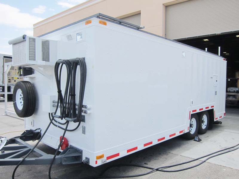A white trailer with an air conditioning unit