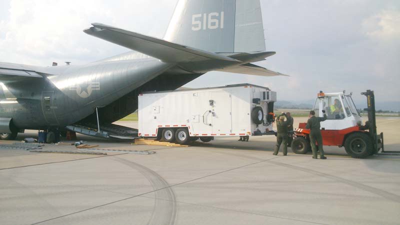 A mobile trailer being transported into an Airplane