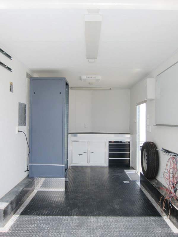 A white interior with a blue cabinet and a single tire