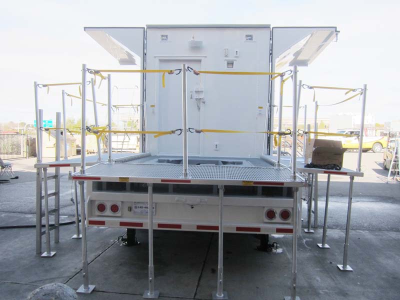 A mobile trailer with yellow safety straps