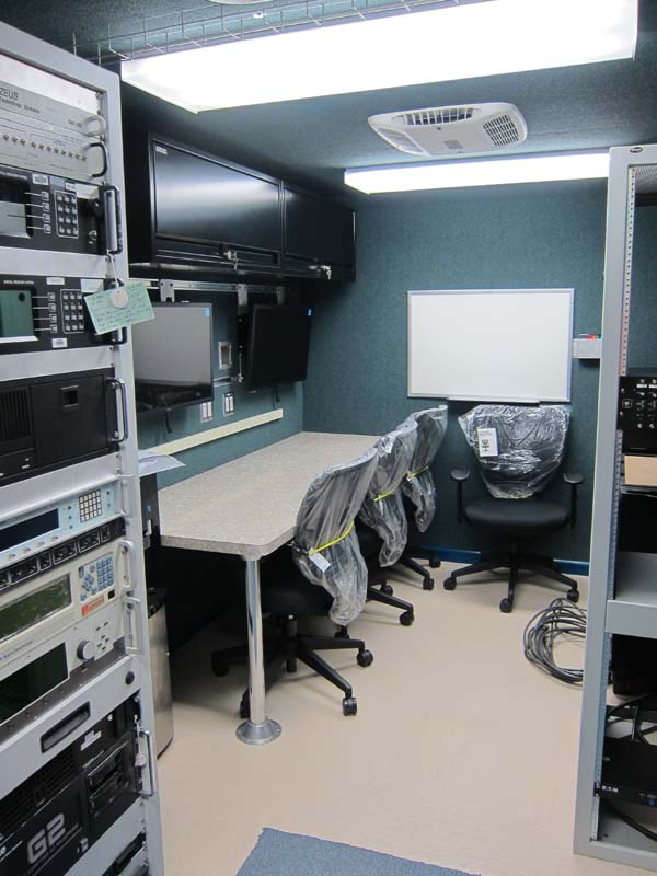 A trailer interior with a complete radio production equipment