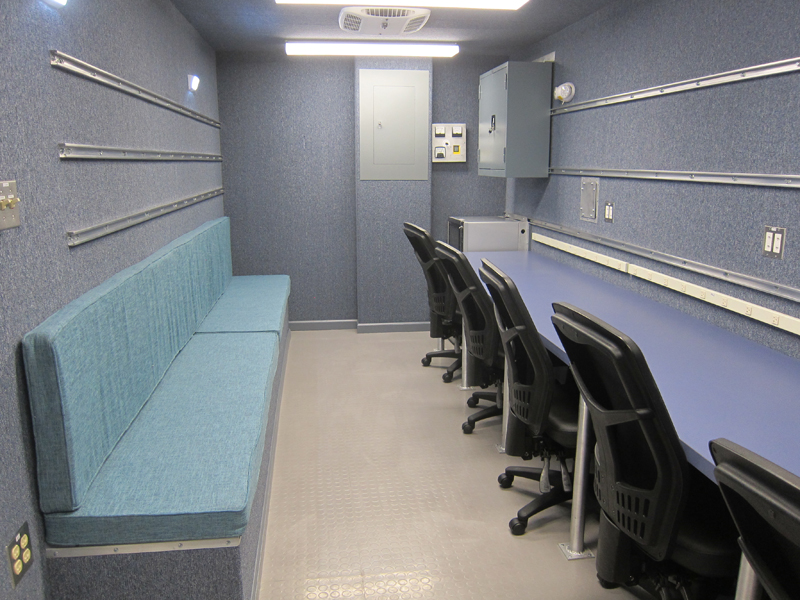 A small room with five office chairs