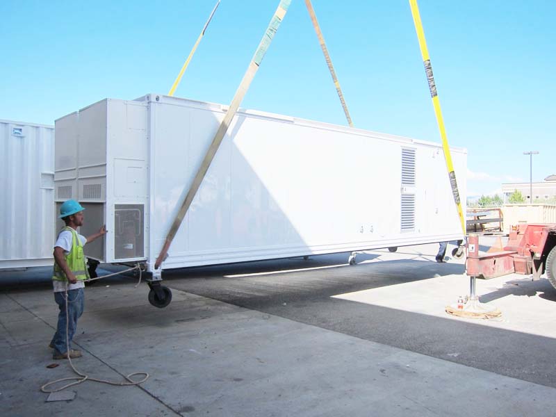 A mobile shelter being lifted off the ground