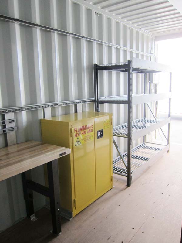 A yellow metal storage beside a wooden table