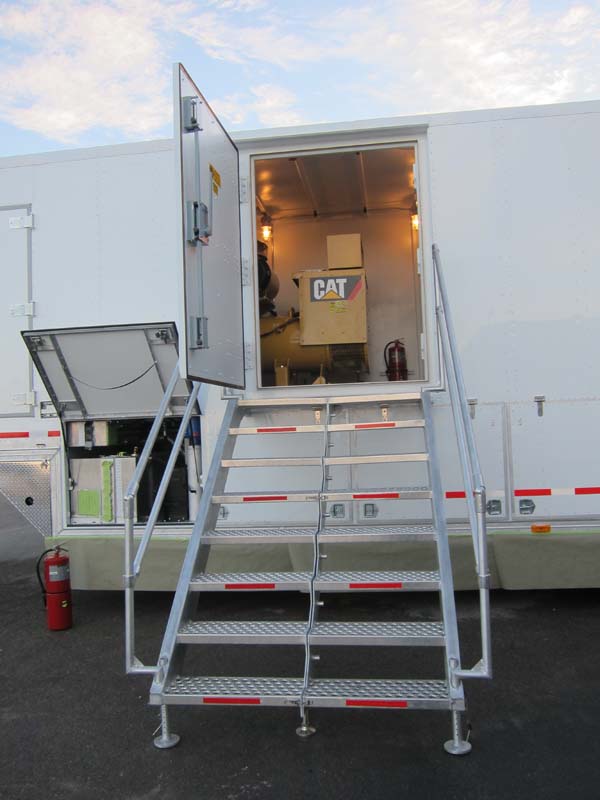 A white mobile shelter with an 8-step staircase