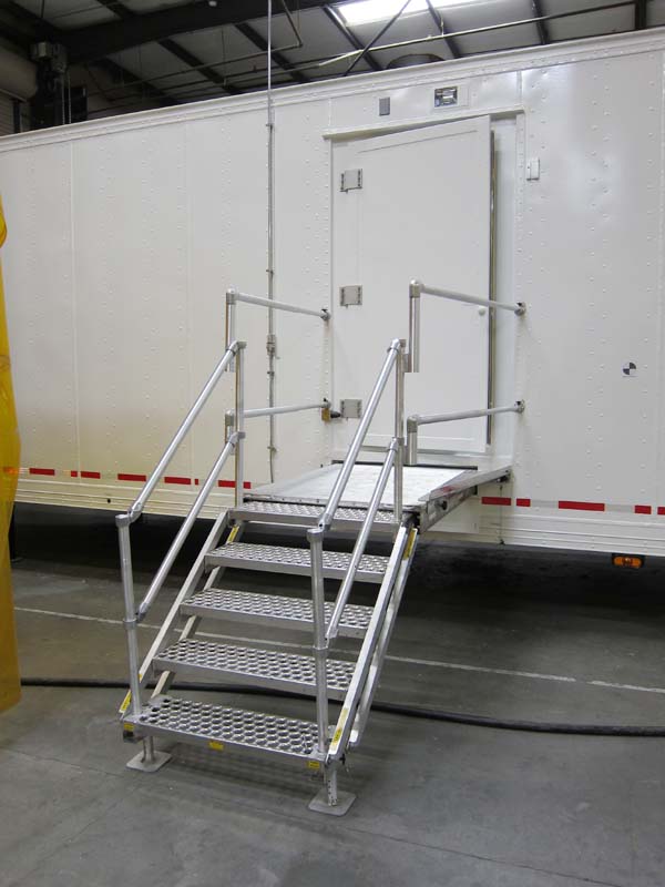 A metal staircase leading to a mobile shelter